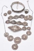 A suite of Chinese white metal filigree jewellery comprising earrings, necklace, brooch and bracelet