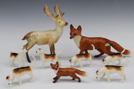 Nine Beswick animals comprising six hounds, two foxes and a deer, tallest 20cm