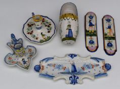 A collection of Quimper faience ware including chamber sticks, one Henriot, pen stand, clog etc,