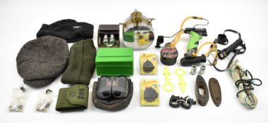 A collection of shooting accessories including two catapults and related ammunition, sectional hip-