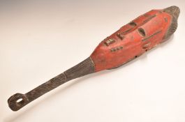 African tribal mask with red painted and carved decoration, 76cm long.