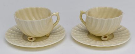 Pair of Belleek Neptune cups and saucers with shell feet, H5.5cm