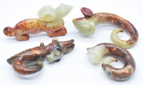 Four Chinese carved green and russet jade / hardstone figures and pendants, tallest 9.5cm