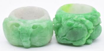 Two Chinese 19th/ early 20thC carved jadeite archer's rings, one in the form of a butterfly and