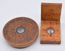 Two Chinese wooden cased compasses/ sun dials, the largest 7.5cm diameter