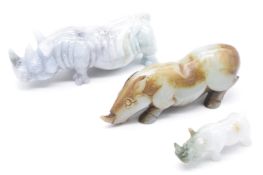 Three Chinese carved jade rhino figures, tallest 3.5cm