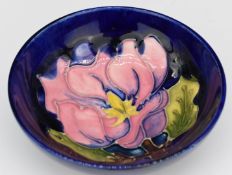 Moorcroft pedestal dish decorated with magnolia on a blue ground, diameter 11.5, H4cm