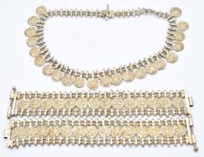 A silver gilt necklace and two bracelets with embossed deity decoration