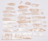 Twenty seven Chinese mother of pearl gaming counters, most formed as fish but including three