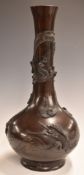 Japanese bronze pedestal bottle vase decorated with birds and dragons in relief, 40cm tall.