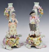 A pair of 19th/20thC German figural candlesticks, probably Volkstedt, H29.5cm