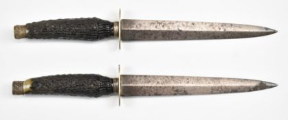 A pair of stag handled hunting daggers with 18cm blades. PLEASE NOTE ALL BLADED ITEMS ARE SUBJECT TO