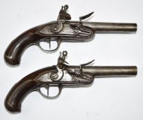 A pair of Queen Anne French flintlock pistols with bird head grips, steel trigger guards, butt