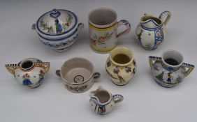 A collection of Quimper faience ware including oversized tankard, porringer, lidded casserole,