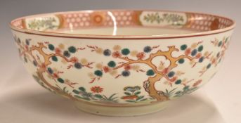 Chinese pedestal punch bowl with prunus decoration in Imari colours, 32cm in diameter