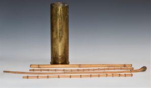 Four swagger sticks including three with bamboo shaft, together with a brass artillery shell,