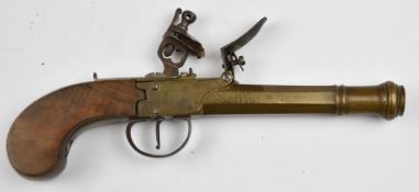 Flintlock pistol with line engraved brass lock, thumb slide safety, walnut grip and 5 inch smooth