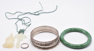 Six Hong Kong silver bangles, a jadeite bangle, hardstone pendants, etc