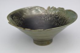 Studio pottery bowl with relief decoration of flowers, indistinct mark to base, diameter 20cm x