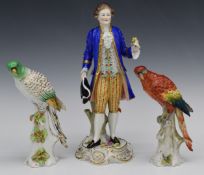 Derby style figure holding a flower and a bird, with gold anchor marks, together with another