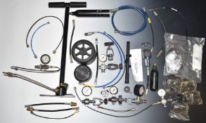 A collection of air rifle and bottle parts and accessories including filling loops, gauges, PCP