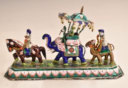 Indian white metal and enamel figural group in the form of figures riding a horse, an elephant and a