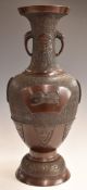 Japanese bronzed pedestal vase with twin stylised elephant handles decorated with auspicious