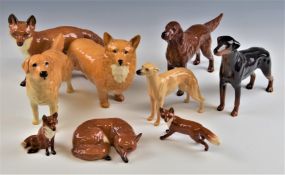 A collection of Beswick dog and fox figures, tallest 11cm
