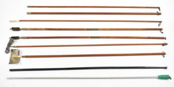 Eight various wooden and metal shotgun and rifle cleaning rods.