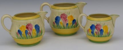 Clarice Cliff for Newport pottery three graduated jugs decorated in the Crocus pattern, tallest