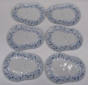 Limoges tea set with oversized cups and cake plates decorated with blue flowers