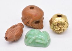 Chinese sandalwood netsuke in the form of a skull, Chinese carved jade phoenix, Chinese yellow metal