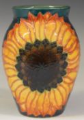 Dennis Chinaworks signed trial vase decorated with sunflowers on a green ground, H13.5cm