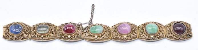 Chinese silver gilt filigree bracelet set with jade, sapphire, tourmaline, ruby and garnet cabochons