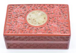 Chinese cinnabar lacquer lidded box set with a carved jade or hardstone roundel, W10 x D65 x H4cm