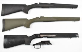 Three composite bolt-action rifle stocks comprising two Howa and one SSG, all with sling mounts.