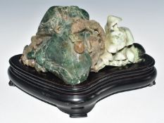Chinese carved jade / jadeite boulder with lizard and fungi decoration, on wooden stand, W26 x D12 x