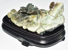 Chinese carved jade / jadeite boulder with crab decoration, on wooden stand, W18 x D8 x H8.5cm
