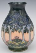 Moorcroft pedestal baluster vase decorated in the Cluny pattern, H20cm, with box