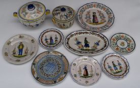 A collection of mostly Henriot Quimper faience ware including covered dishes figurally decorated