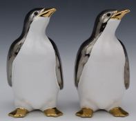 A pair of ceramic penguins with cream and chrome finish, 24.5cm tall.