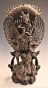 Balinese finely carved figure of the Hindu god Vishnu rinding Garuda, 42cm tall.