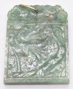 A carved jadeite pendant/ plaque depicting flowers, 4.5 x 3.5cm
