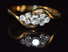 An 18ct gold ring set with seven diamonds in a twist setting, 2.5g, size M