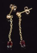 A pair of 9ct gold earrings set with marquise cut garnets, 0.8g, 3cm drop