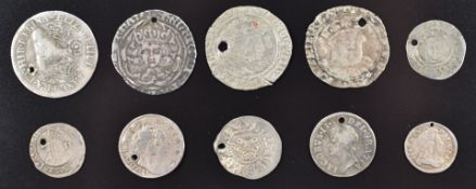 A collection of ten hammered and early milled silver coinage, each with a small pierced hole,