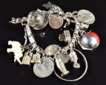 A silver charm bracelet with 15 silver charms including pheasant, anchor, telephone box, St