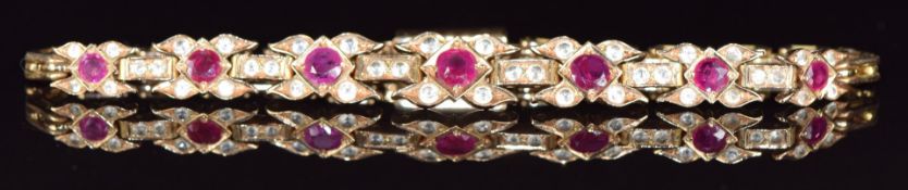 A 14ct gold bracelet set with cushion/ round cut rubies and white sapphires, 11.7g, 18cm long