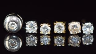 Four 18ct gold and two 9ct gold earrings both set with diamonds, the largest approximately 0.15ct
