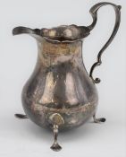 George V hallmarked silver milk jug, raised on three feet, Birmingham 1930, maker William Hutton &